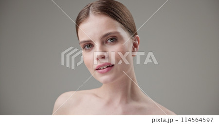 Beauty, health, cosmetics, anti-aging therapy and skin care concept - young beautiful brunette Caucasian woman posing and looking at the camera with a calm confident look Beauty, health, cosmetics, anti-aging therapy and skin care concept - young beautiful brunette Caucasian woman posing and looking at the camera with a calm confident look 114564597