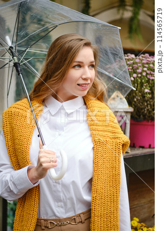 Autumn portrait of a young woman with an umbrella 114565719