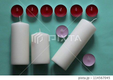 Decorative candles arranged in a row. On a mint background. Decorative candles arranged in a row. On a mint background. 114567045