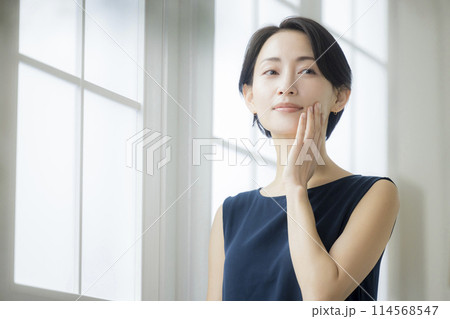 リビングで鏡を見るミドル女性　 114568547