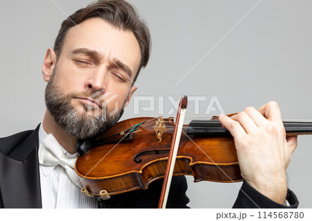 Man classic violinist at musical elegant performance 114568780