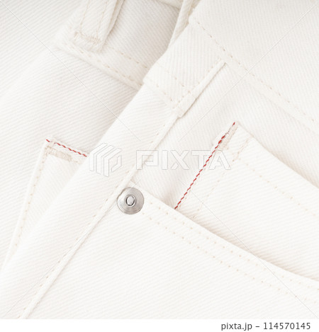 Pocket detail of milky raw denim jeans with red selvedge and metal fittings 114570145