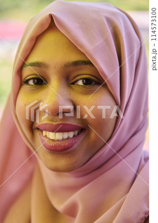 Close up Portrait of a Joyful Middle Eastern Hijabi 114573100
