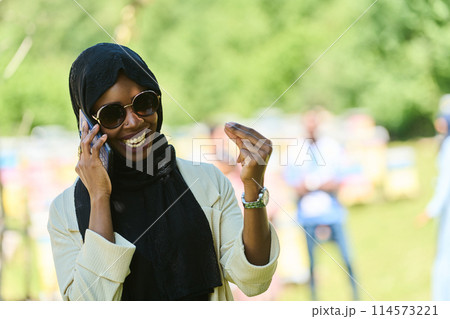 Empowered Middle Eastern Muslim Woman in Hijab Balances Modern Technology and Traditional Beekeeping Business Empowered Middle Eastern Muslim Woman in Hijab Balances Modern Technology and Traditional Beekeeping Business 114573221