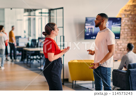 Young business colleagues, including an African American businessman, engage in a conversation about business issues in the hallway of a modern startup coworking center, exemplifying dynamic problem Young business colleagues, including an African American businessman, engage in a conversation about business issues in the hallway of a modern startup coworking center, exemplifying dynamic problem 114573243