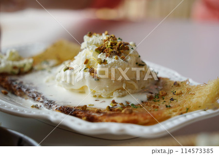 Vanilla ice cream topped with nut powder Vanilla ice cream topped with nut powder 114573385