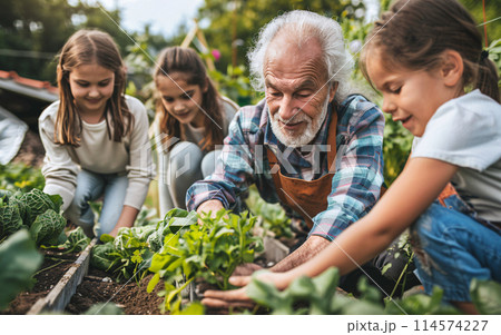 Happy family of different generations working and gardening together in a family garden in the backyard 114574227