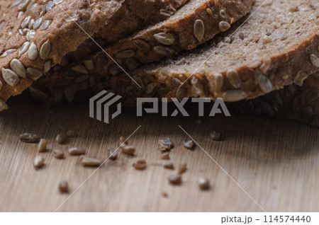 Sliced rye bread with sunflower seeds on a wooden board 114574440