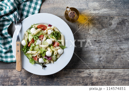 Pasta salad with vegetables and mozzarella cheese on wooden table 114574851