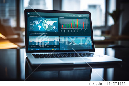 Laptop screen with charts and graphs on table, business and investment concept 114575452