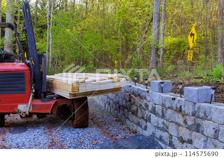 Using forklift, contractor delivers building materials on construction site 114575690