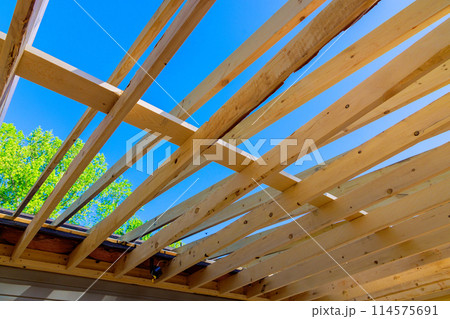 New house with wooden framing, beams, studs, an unfinished interior 114575691