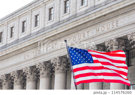 USA national flag waving in the wind in front of United States Court House in New York USA national flag waving in the wind in front of United States Court House in New York 114576260