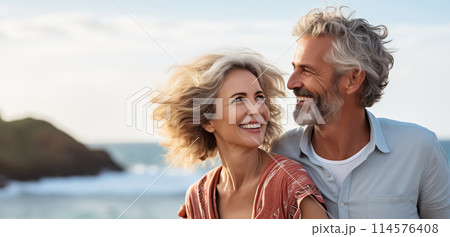 Summer portrait happy smiling mature couple together on sunny coast, enjoying beach vacation at sea 114576408