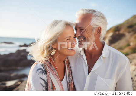 Summer portrait happy smiling mature couple together on sunny coast, enjoying beach vacation at sea 114576409