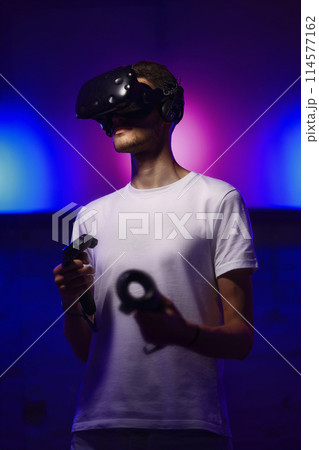 The player plays the game using virtual reality. Neon style. 114577162