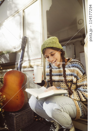 An enchanting portrayal of a trendy young woman embracing retro hippie fashion. An enchanting portrayal of a trendy young woman embracing retro hippie fashion. 114577294