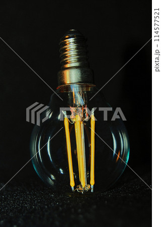 Decorative light bulb with yellow spirals. 114577521