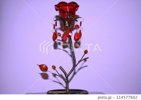 Candlestick in the shape of a flower.With a red bud and decorated with green stones. 114577682