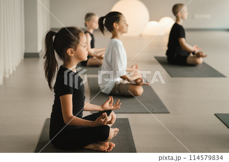 Children do Yoga in the fitness room. Children's gymnastics Children do Yoga in the fitness room. Children's gymnastics 114579834