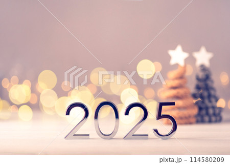 Metal numbers 2025 on table with bokeh lights. 114580209