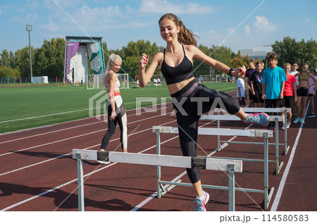 Group of young athletes training at the stadium 114580583