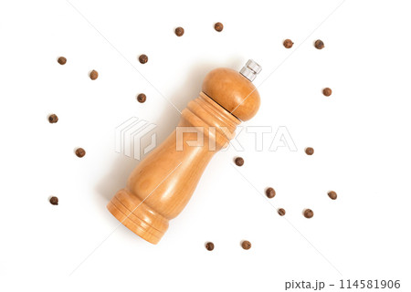 Wooden pepper mill and peppercorns isolated on white background. Cooking concept, top view 114581906