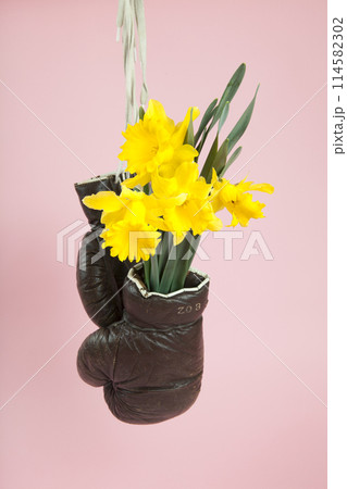 a pair of old boxing gloves hacked to become a vase 114582302