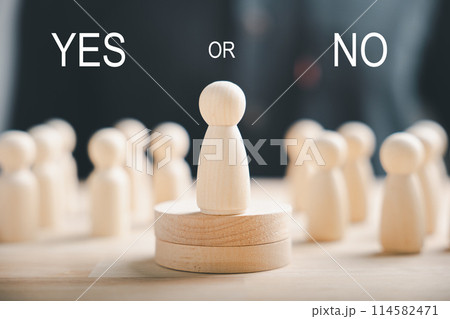 Wooden figures on a cube display yes or no symbols. Depicts open-mindedness in elections involving volunteers and candidates. Think With Yes Or No Choice. 114582471