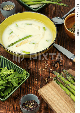Asparagus soup on wooden background. 114582914