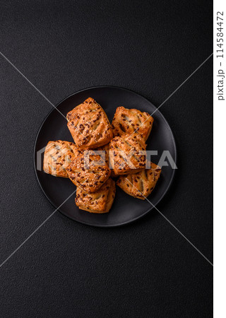 Triangular puffs with feta cheese, tomatoes with salt, spices and herbs 114584472