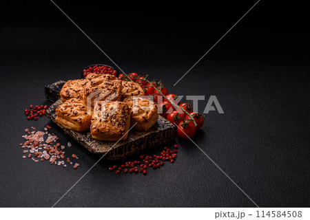 Triangular puffs with feta cheese, tomatoes with salt, spices and herbs Triangular puffs with feta cheese, tomatoes with salt, spices and herbs 114584508