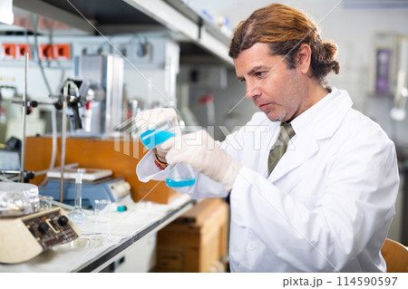 Portrait of an adult male using equipment to work in a laboratory Portrait of an adult male using equipment to work in a laboratory 114590597
