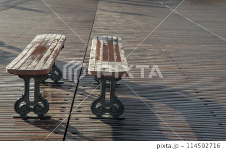 Romantic couple wooden benches made to wooden and iron stands on pedestrian bridge. Romantic couple wooden benches made to wooden and iron stands on pedestrian bridge. 114592716
