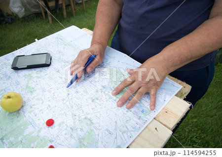 Senior woman looking at a map of Barcelona preparing for a trip, tourism in Europe. Senior woman looking at a map of Barcelona preparing for a trip, tourism in Europe. 114594255