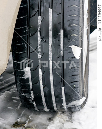 Summer tire in the snow, driving with tires unsuitable for the season, unsafe and dangerous traffic Summer tire in the snow, driving with tires unsuitable for the season, unsafe and dangerous traffic 114594967