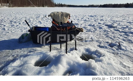 Winter fishing, catching a fish in the North of Sweden Winter fishing, catching a fish in the North of Sweden 114596263