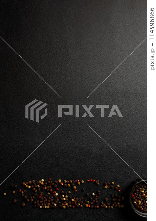 Colored peppercorns on a black background 114596866