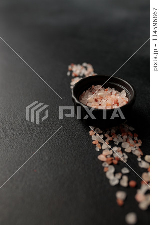Colored Himalayan salt on a black background. Straight line Space for text 114596867