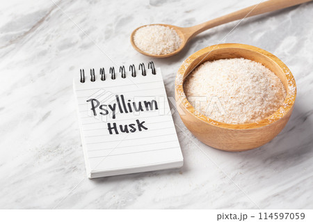 Psyllium husk in wood bowl and spoon with psyllium husk word on notebook on white marble table 114597059