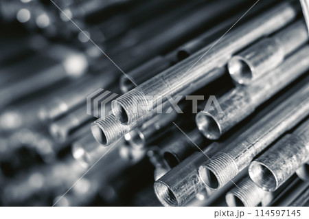 metal gas pipe store stack pile on shelf black and white vintage color tone. watering pump sewer system industry equipment metal gas pipe store stack pile on shelf black and white vintage color tone. watering pump sewer system industry equipment 114597145