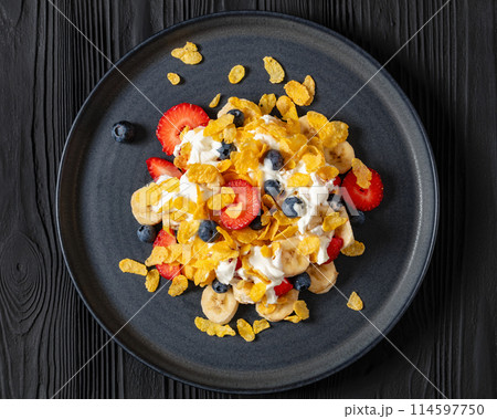 fresh berries, banana with corn flakes and yogurt fresh berries, banana with corn flakes and yogurt 114597750