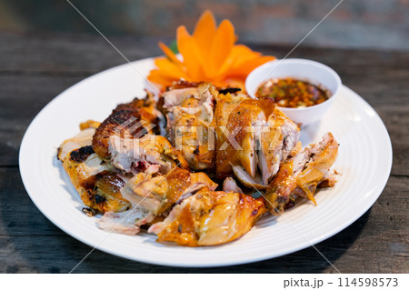 Grilled chicken on a plate ready to serve. Thai food Grilled chicken on a plate ready to serve. Thai food 114598573