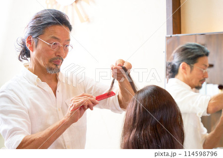 ヘアサロンで働くベテラン美容師 ヘアサロンで働くベテラン美容師 114598796