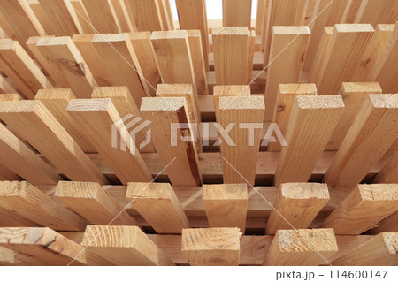 Stacks of pine lumber. Edged board. Wood harvesting workshop. Close-up of wooden planks. 114600147