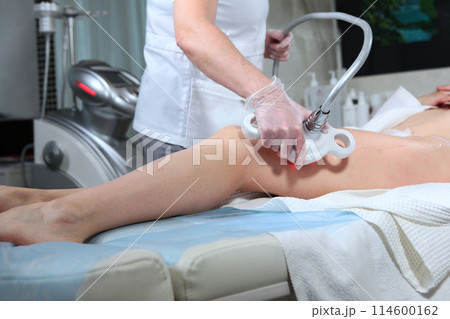Fight against cellulite. Body lift. Radio wave lifting for the body. This affects cellulite and age-related flabbiness. An unrecognizable person. Concept of beauty clinics. 114600162
