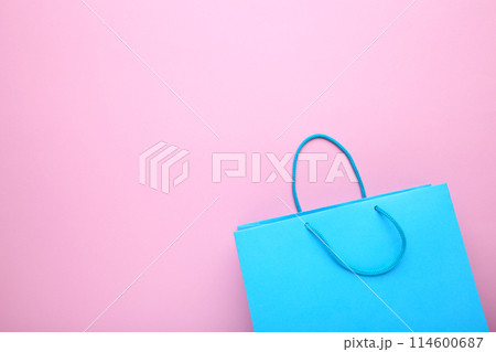 Blue paper shopping bag on pink background 114600687