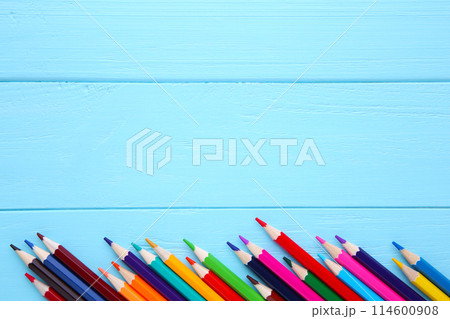 Many different colored pencils on blue wooden background Many different colored pencils on blue wooden background 114600908