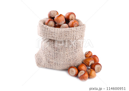 Hazelnuts in the sack isolated on white background Hazelnuts in the sack isolated on white background 114600951