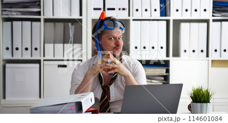 Man wearing suit and tie in goggles with snorkel 114601084
